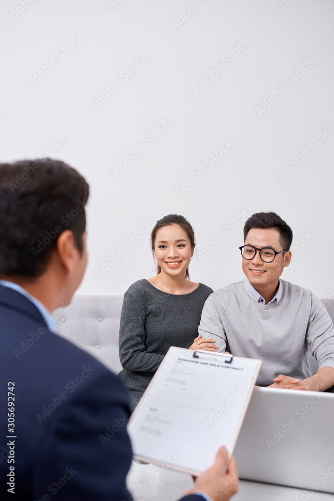 Happy young couple hold each otherâ??s hands listening to female agent, planning wedding, consulting