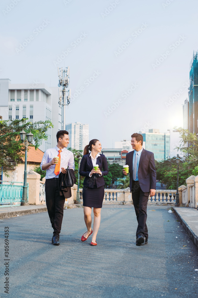 Elegant businesspeople walking in a modern city.