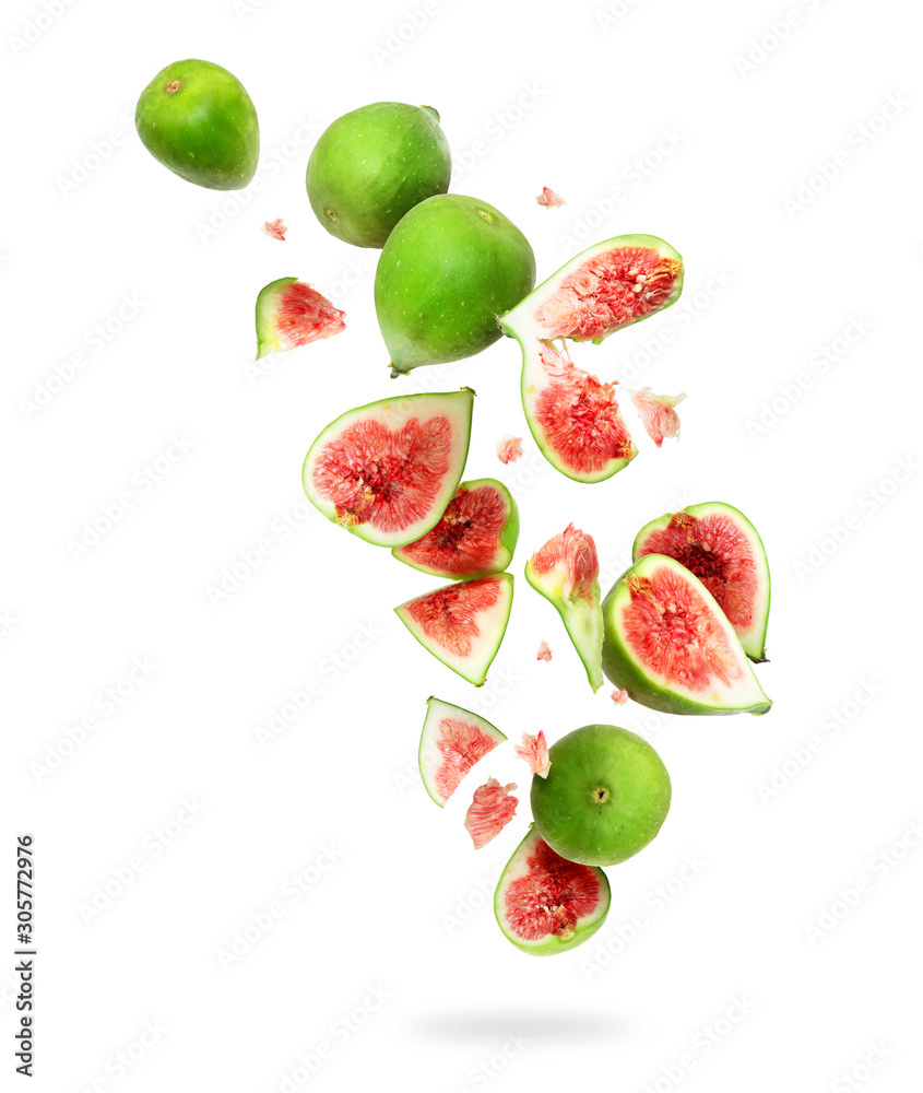 Whole and sliced ripe green figs in the air, isolated on a white background