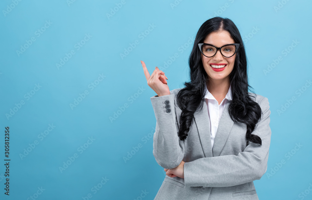 Young woman in a thoughtful pose on a blue background