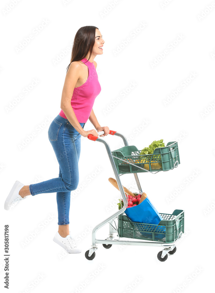 Young woman with shopping cart on white background