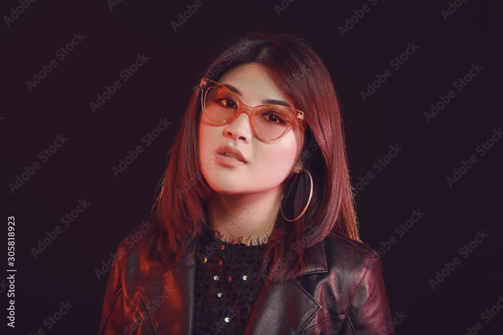 Portrait of young Asian woman on dark background