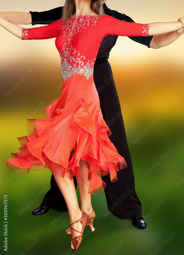 Man and a woman dancing Salsa on blur background