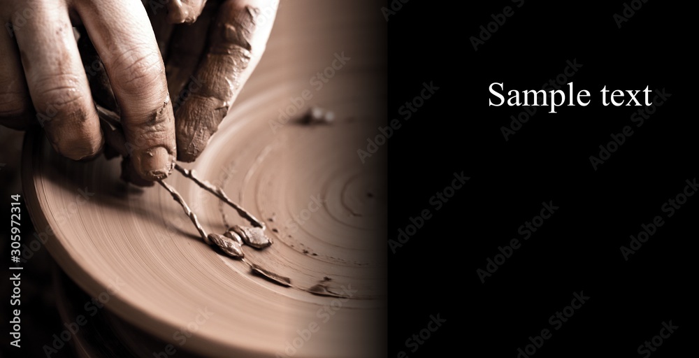 Hands of potter making clay pot on black background