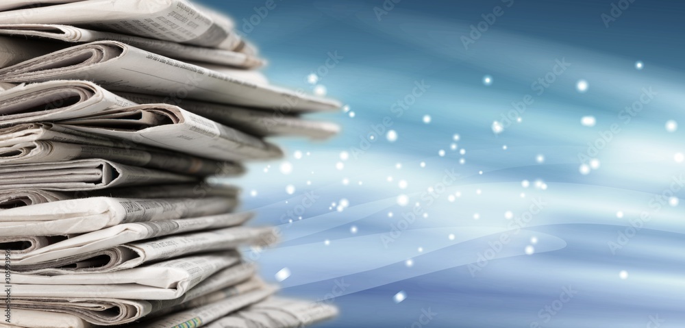 Pile of newspapers on a blue magic background