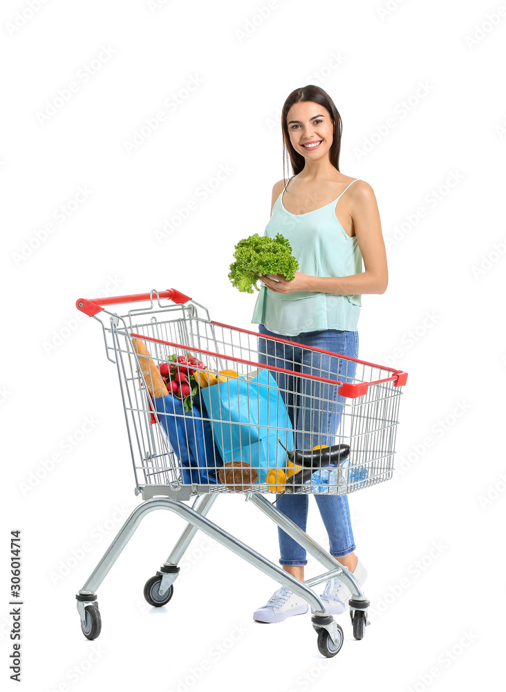 Young woman with shopping cart on white background