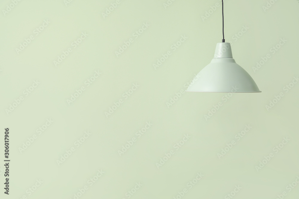 Stylish lamp on color background