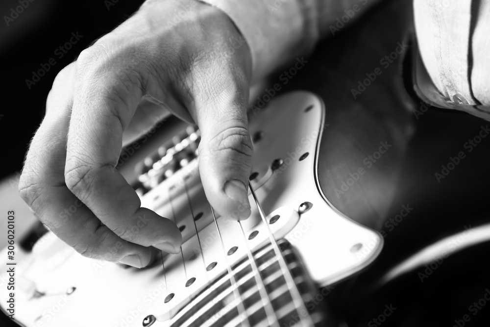 Black and white photo of man with guitar, closeup