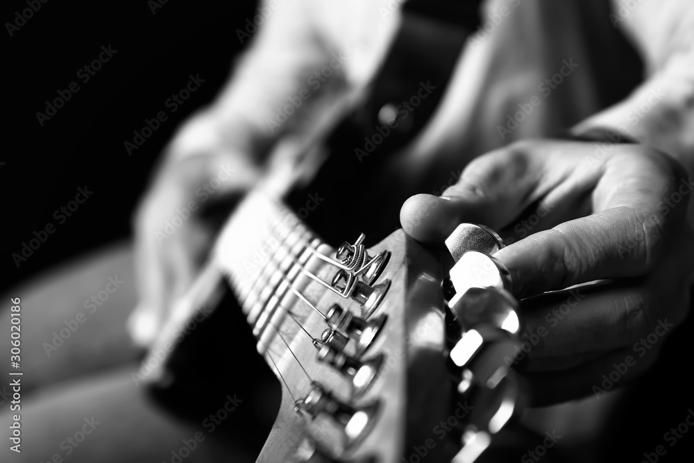 Black and white photo of man with guitar, closeup