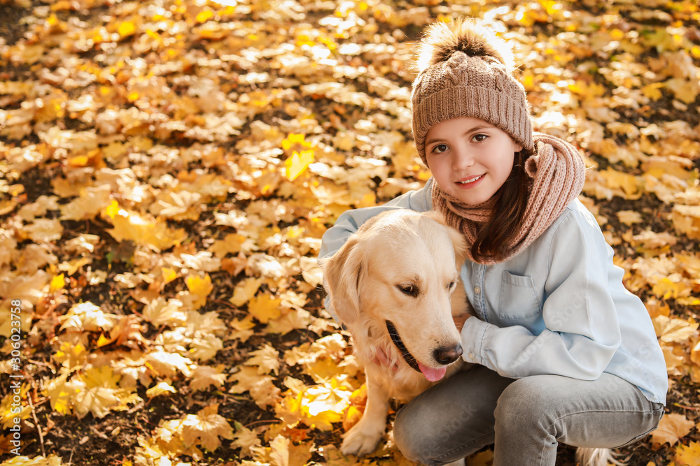 Little girl with cute dog in autumn park