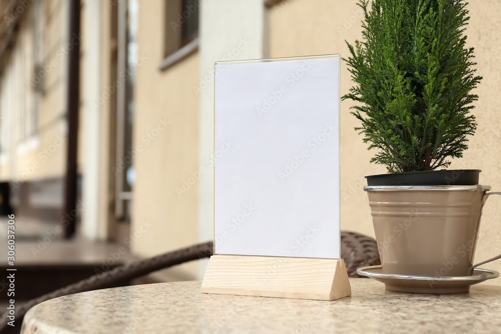 Empty menu on table in outdoor cafe