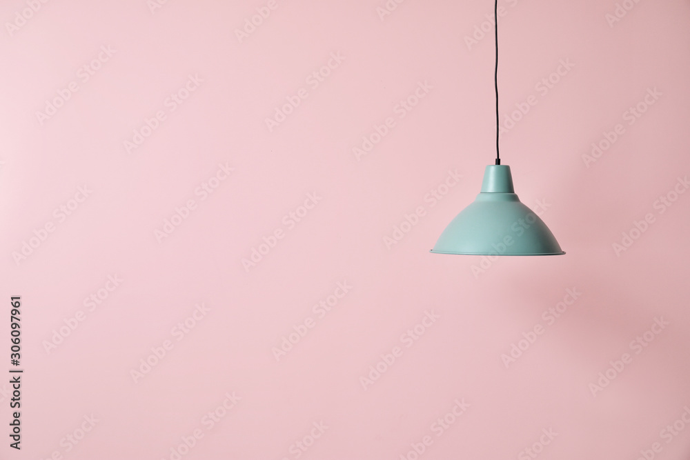 Stylish lamp on color background