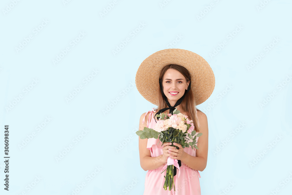 Beautiful young woman with bouquet of carnation flowers on color background