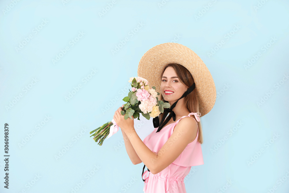 Beautiful young woman with bouquet of carnation flowers on color background