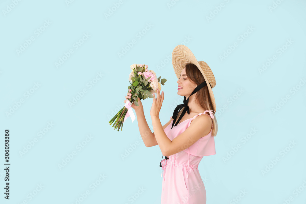 Beautiful young woman with bouquet of carnation flowers on color background