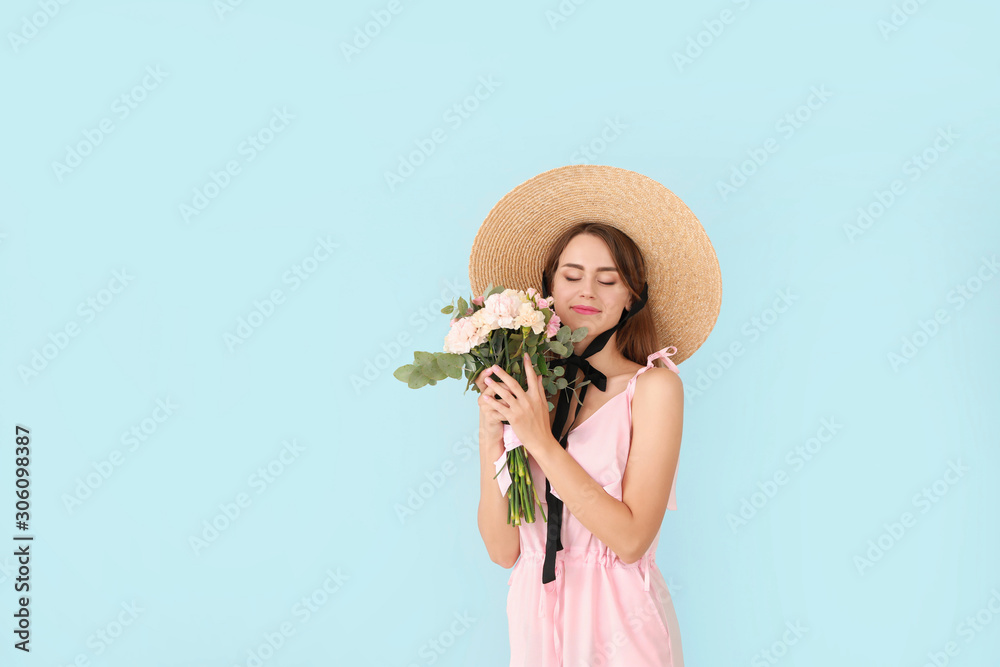 Beautiful young woman with bouquet of carnation flowers on color background