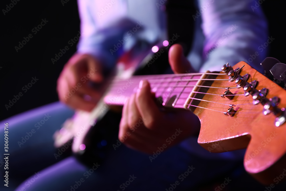 Man playing guitar, closeup view