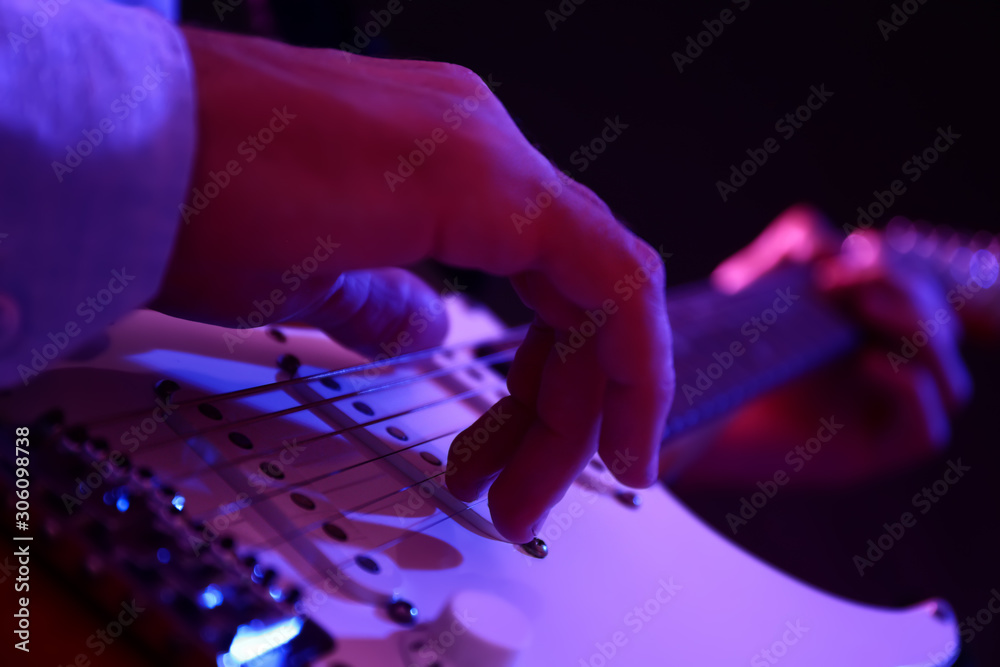 Man playing guitar, closeup view