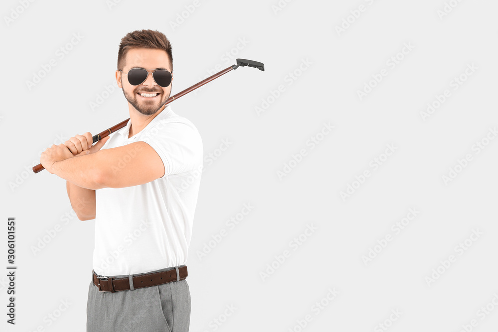 Handsome male golfer on white background