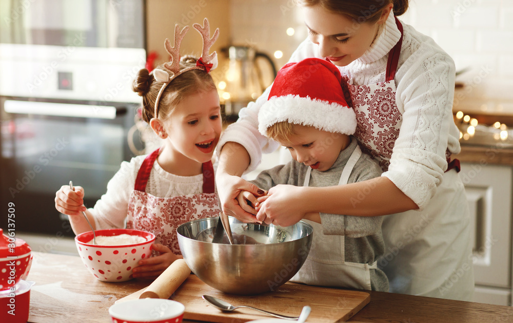 happy family mother and children bake christmas cookies