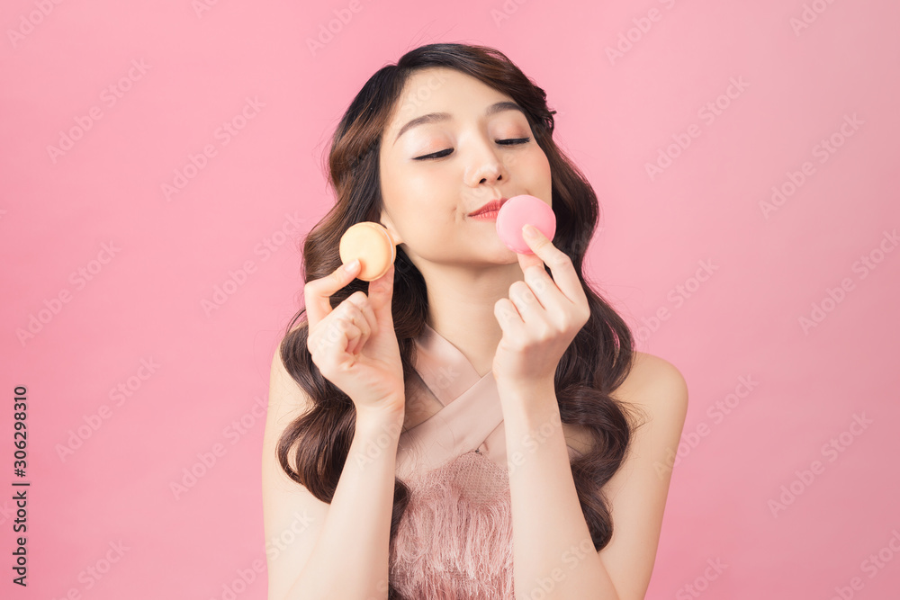 portrait of happy asian woman with macaron looking at camera