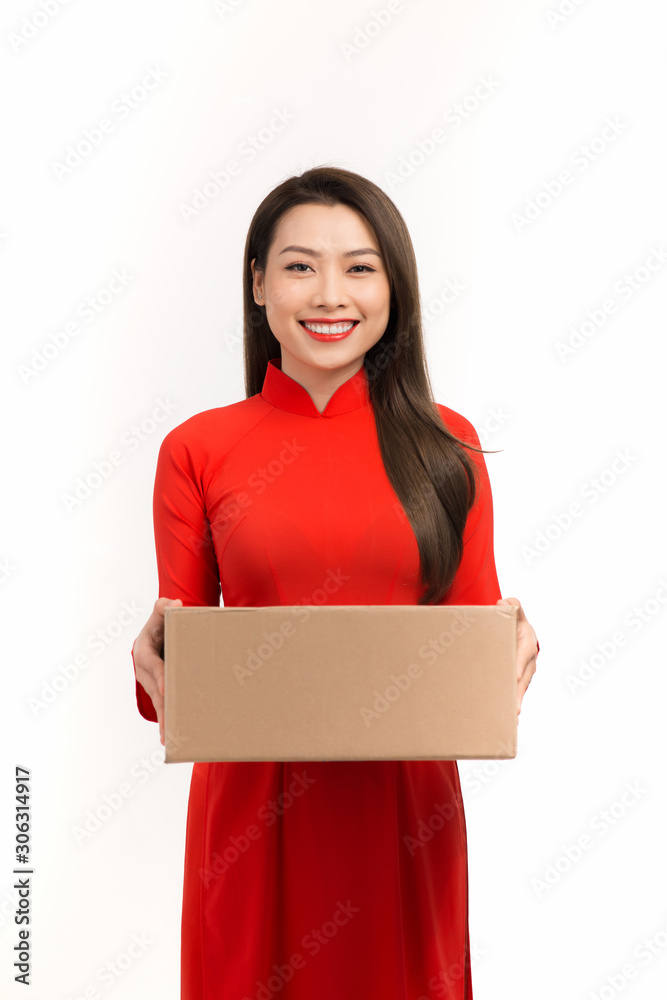 Happy Lunar New Year. Beautiful young asian woman holding gift box,  smile and showing present purch