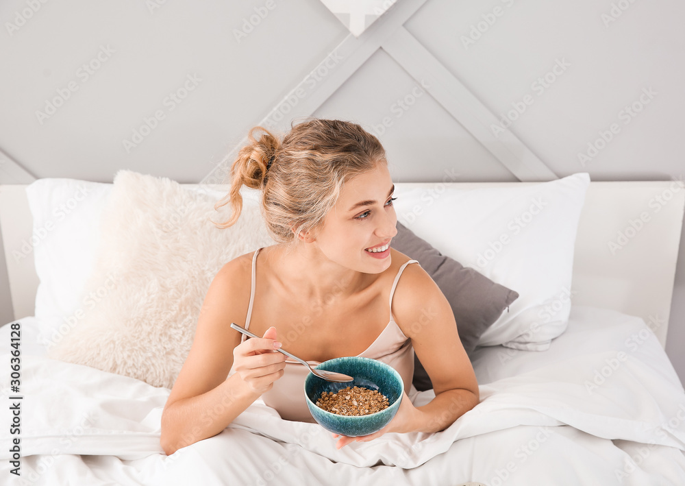 Morning of beautiful young woman having breakfast in bed