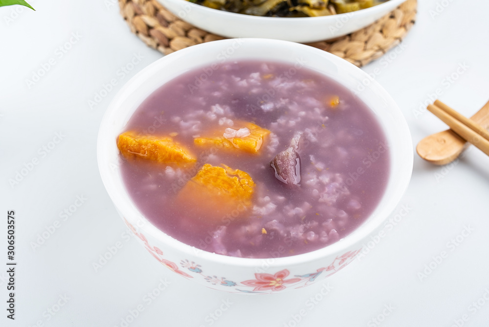 Purple sweet potato porridge in a bowl on white background