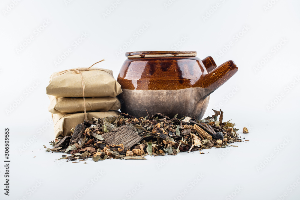 Chinese medicinal herbs and medicine jars on white background