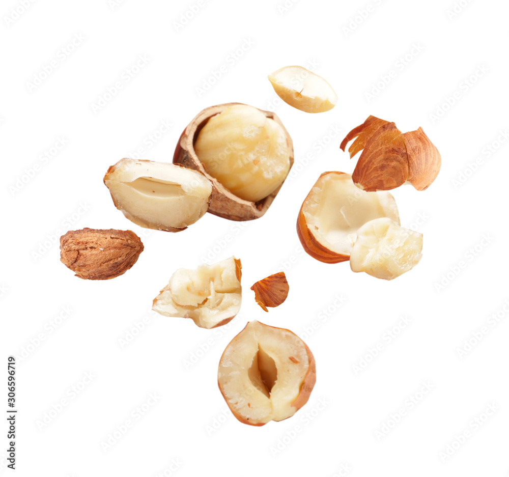 Falling hazelnuts on white background