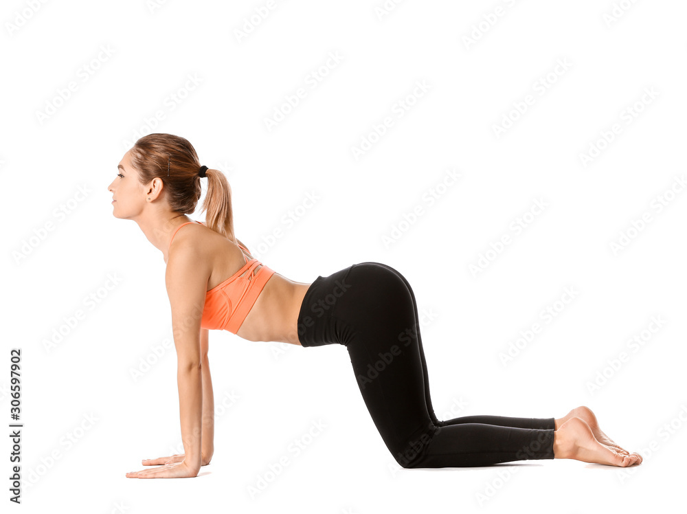 Beautiful young woman practicing yoga on white background