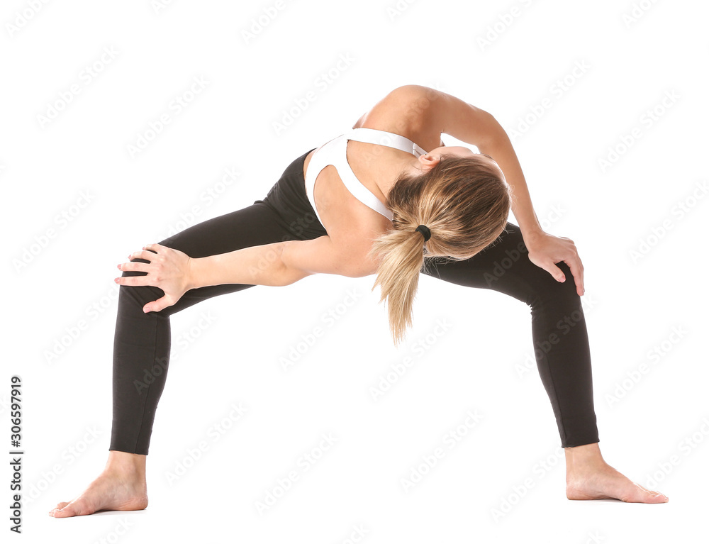 Beautiful young woman practicing yoga on white background