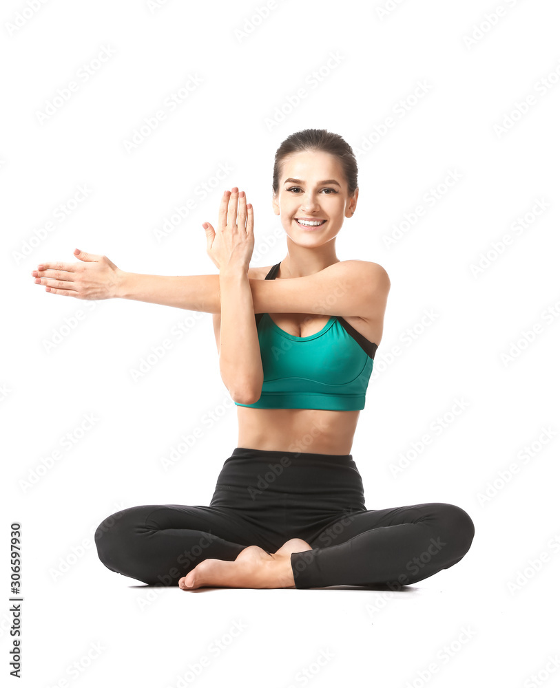 Beautiful young woman practicing yoga on white background