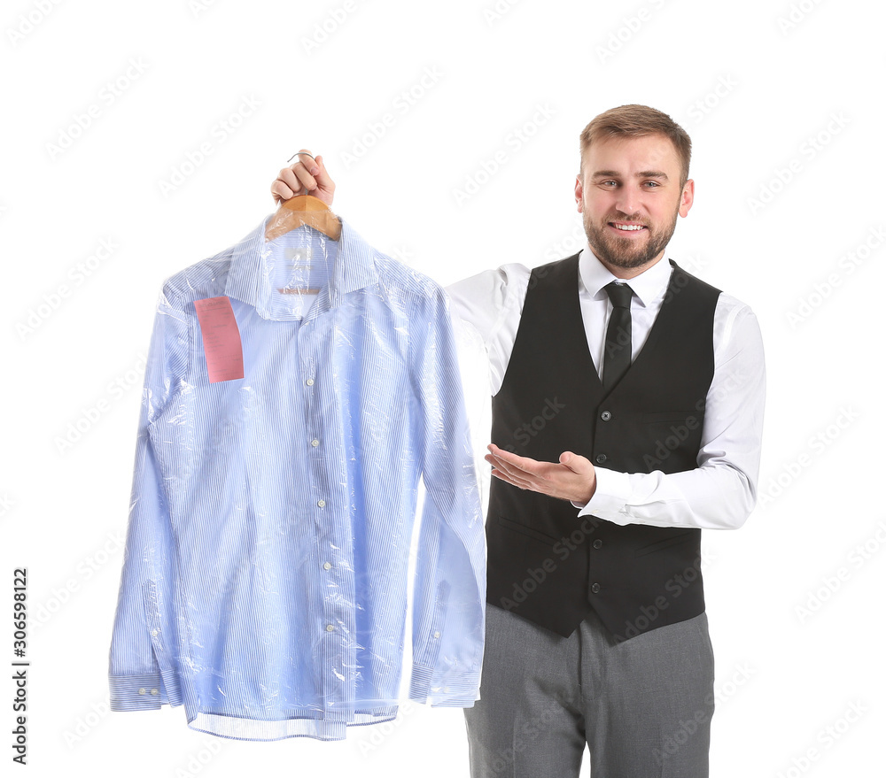 Male worker of modern dry-cleaners with clothes on white background