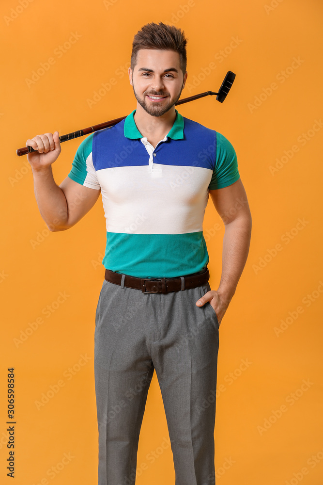 Handsome male golfer on color background