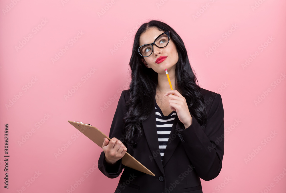 Office woman with a clipboard on a pink background