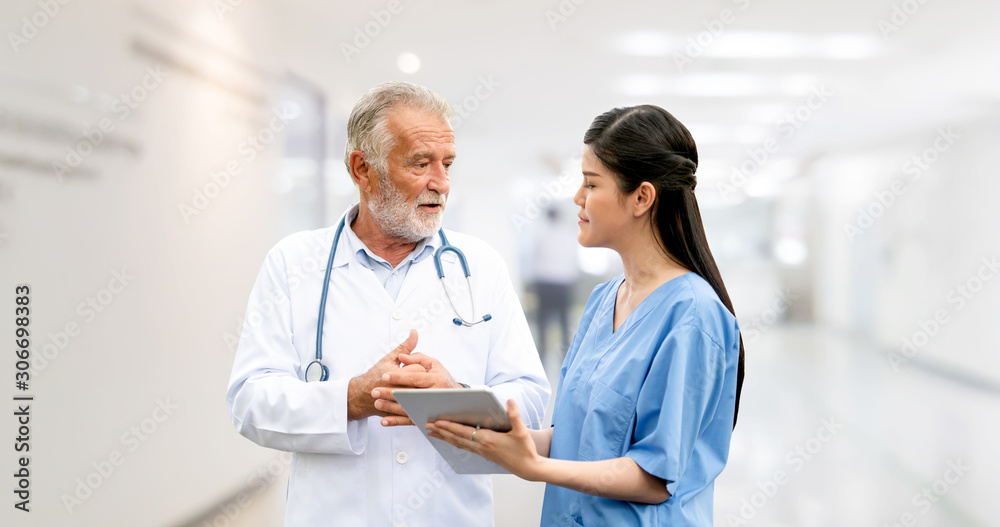 Senior doctor working with young doctor in the hospital. Medical healthcare staff and doctor service