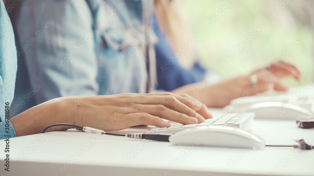 Close up shot of businesswoman hand typing and working on desktop computer on the office desk. Busin