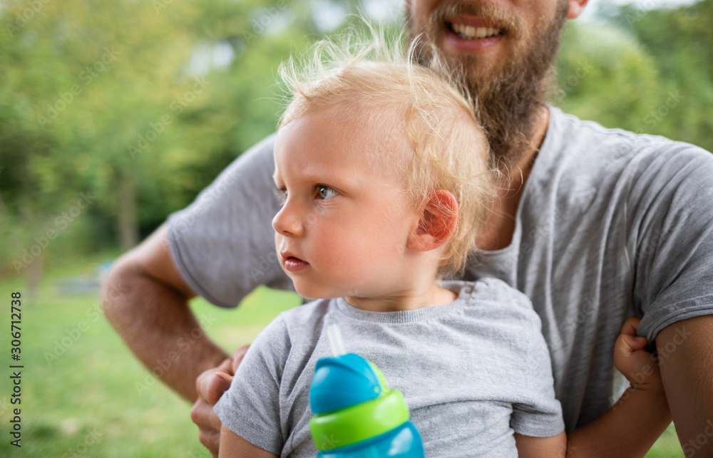 Cute toddler boy with his dad outdoor