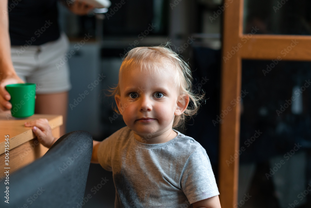 Little child boy looking at camera at home