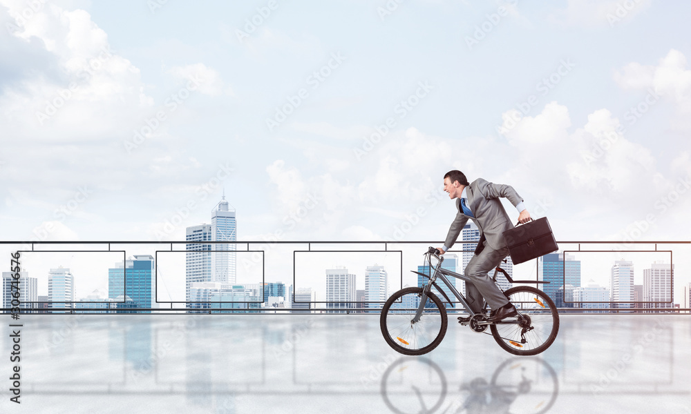 Man riding bicycle on penthouse balcony