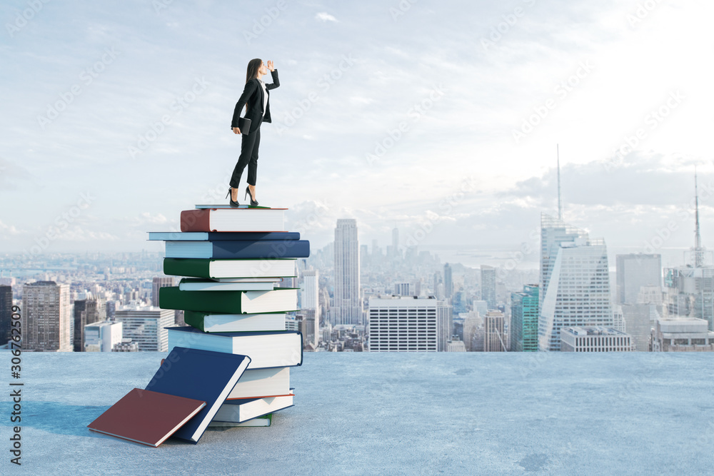 Businesswoman standing on book