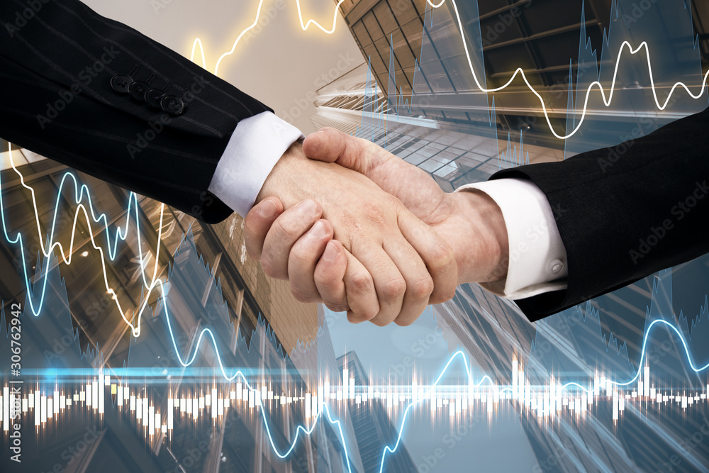 businessmen handshake on blurry city background