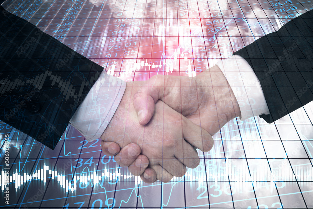 Businessmen handshake on building background