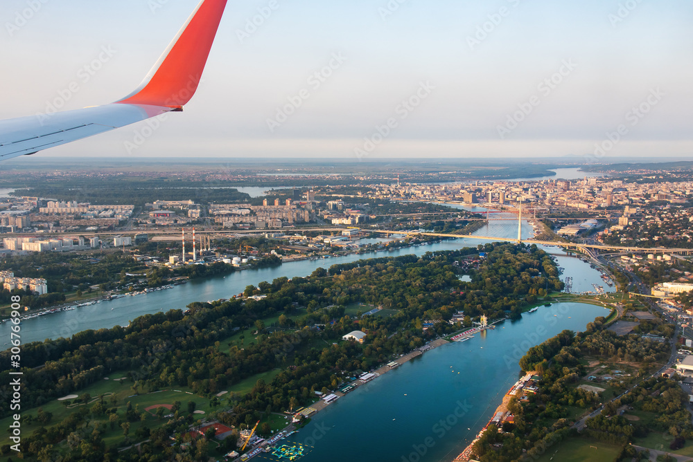 Airplane flying over Belgrade cityscape in Serbia