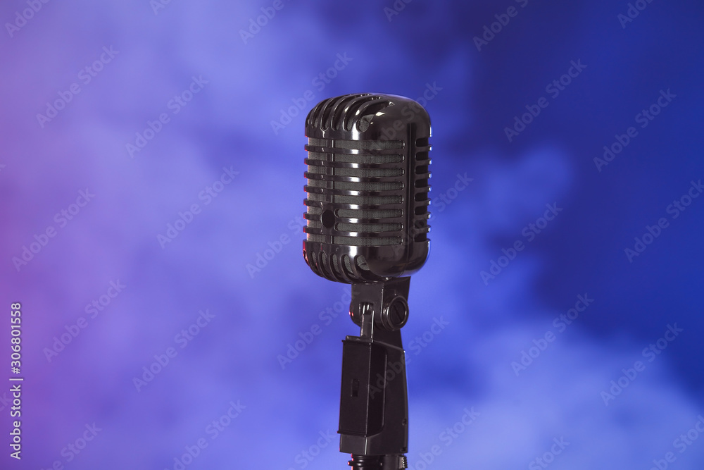 Retro microphone on dark color background with smoke