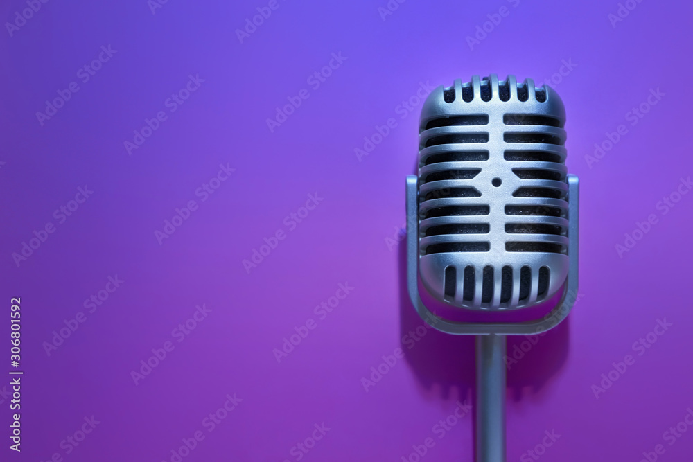 Retro microphone on color background