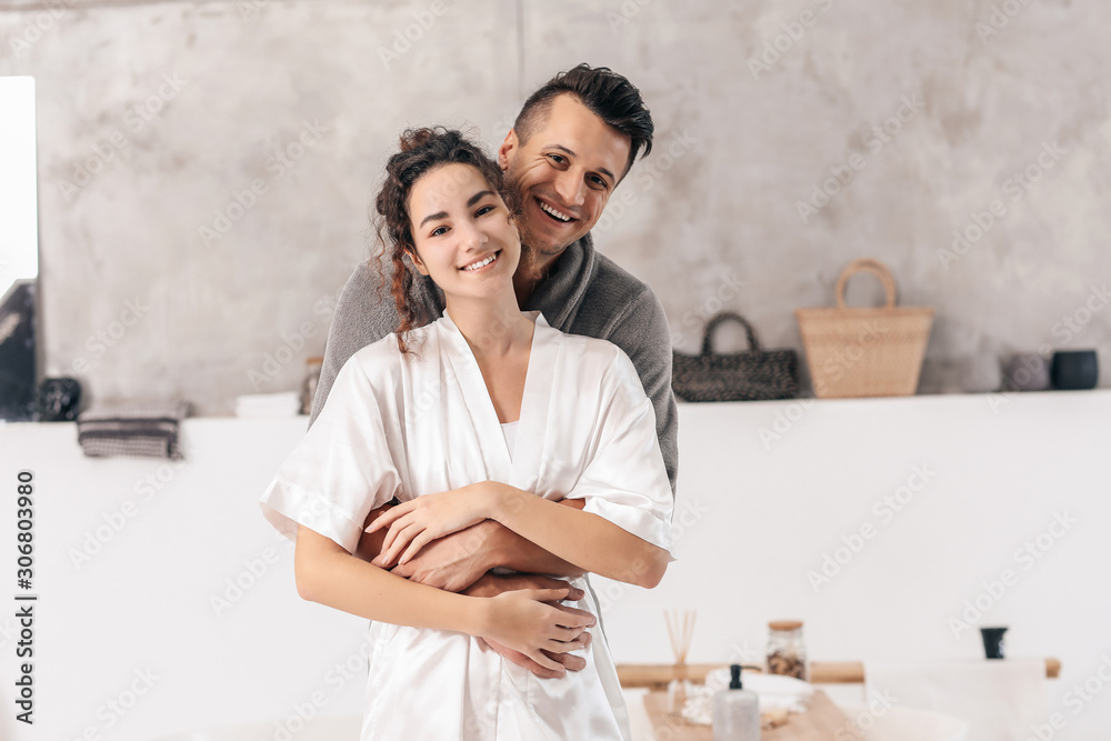 Happy young couple in bathroom at home