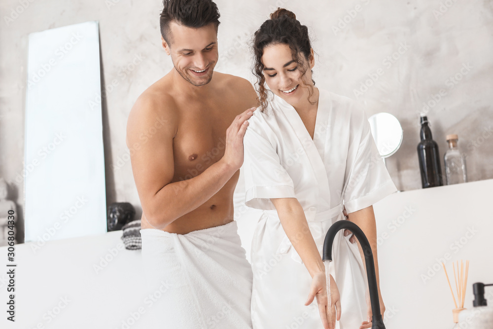 Happy young couple in bathroom at home