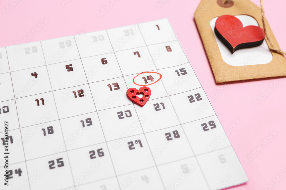 Calendar with marked date of Valentines Day on color background